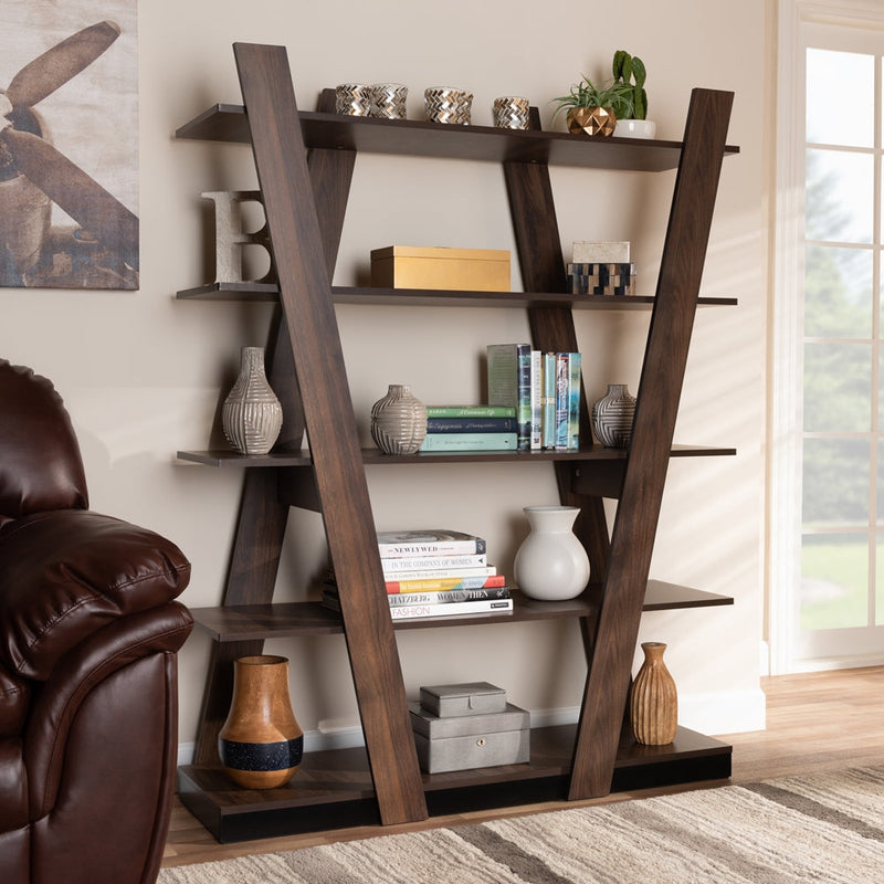 Modern freestanding open shelving unit with dark wood V-shaped frame, styled with books, decorative vases, boxes, and plants in a contemporary living room.