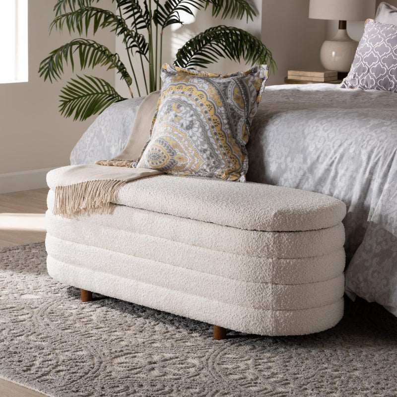 Boucle storage bench at the foot of the bed