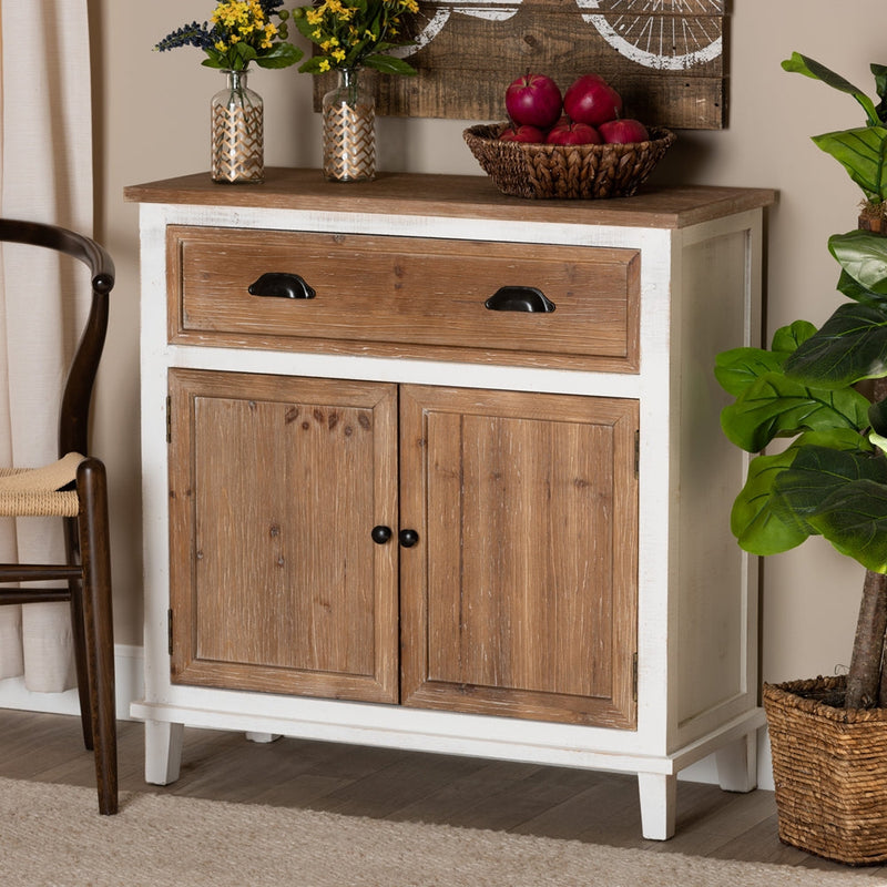 Rustic wooden kitchen cabinet with drawer and two doors, styled with plants and fruit basket.