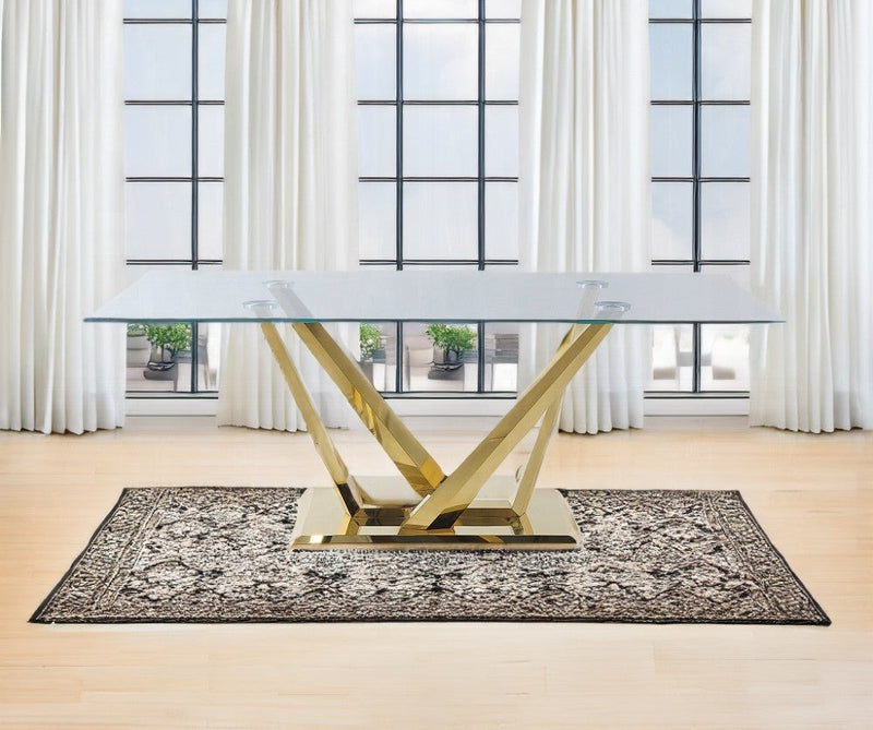Glass dining table on a rug and in front of a very large window.