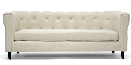 Beige tufted fabric sofa with cushioned seat and modern design