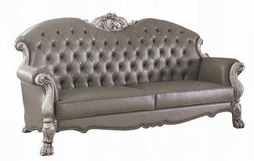 Classic tufted leather sofa with ornate carved wood frame and vintage design